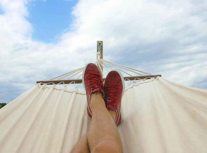 The feet of somebody lying in a hammock