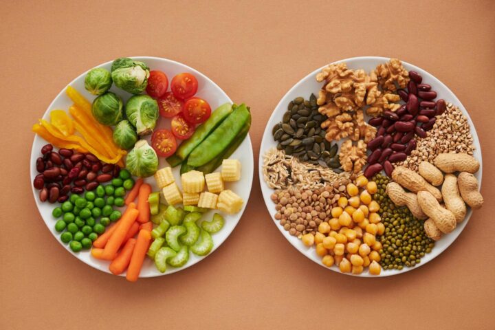 Two plates of vegetables and various grains and legumes